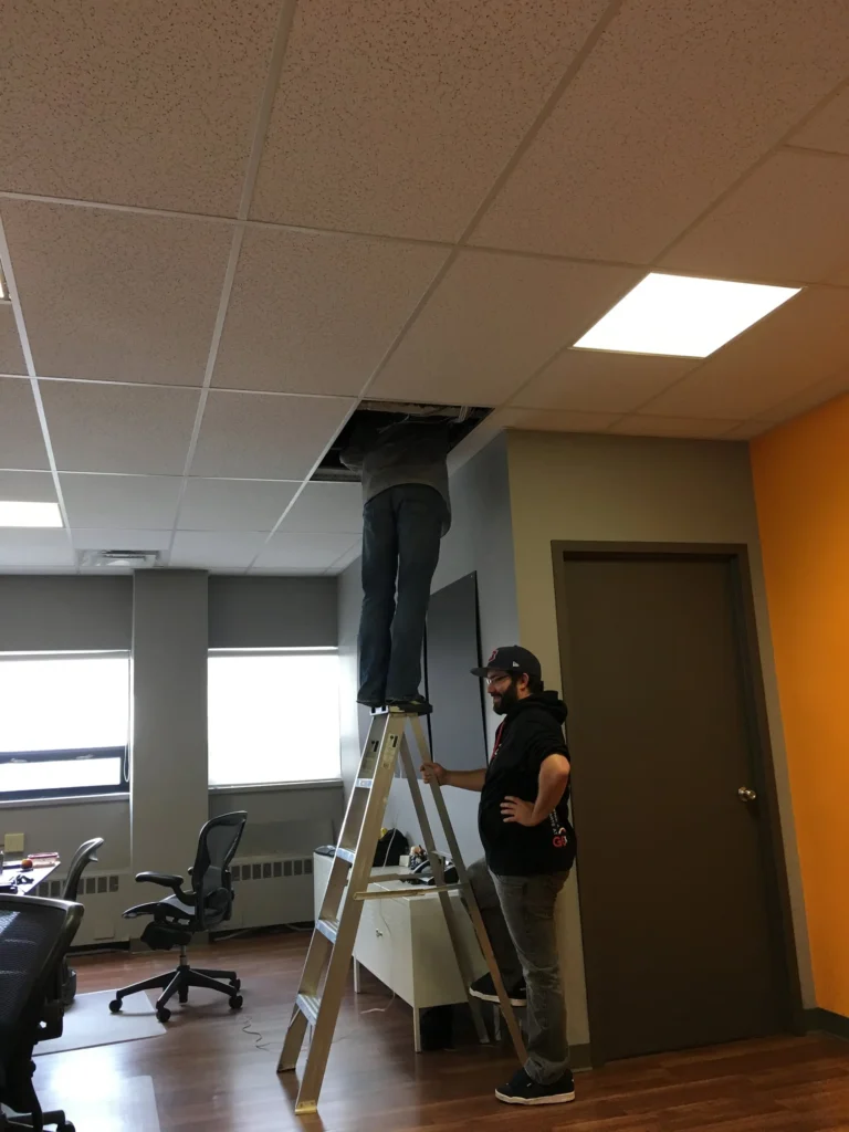 Seb finding a way to climb over the wall through the ceiling into his locked office