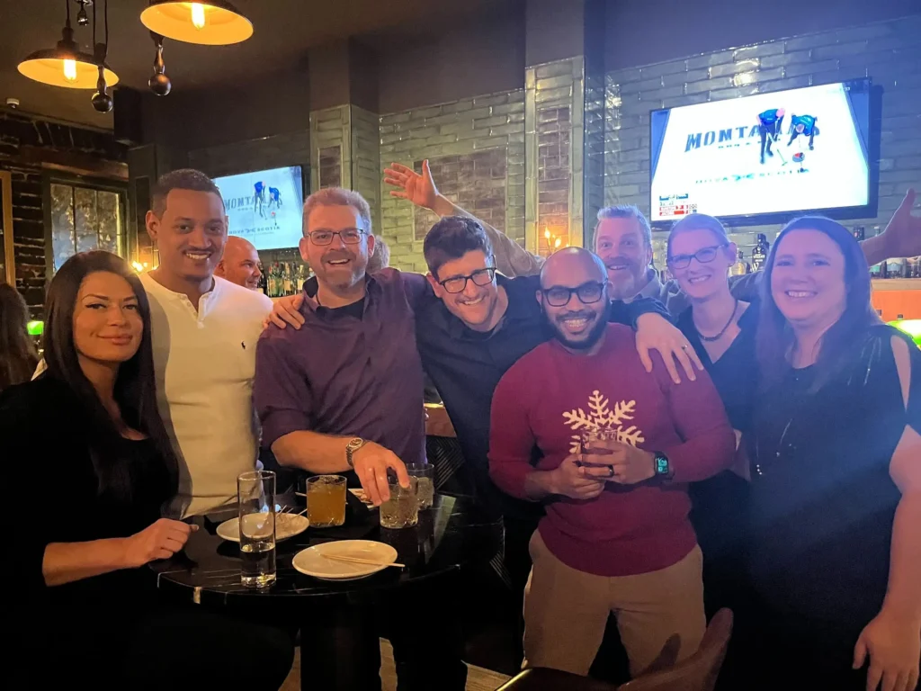 team posing at holiday social party 2026