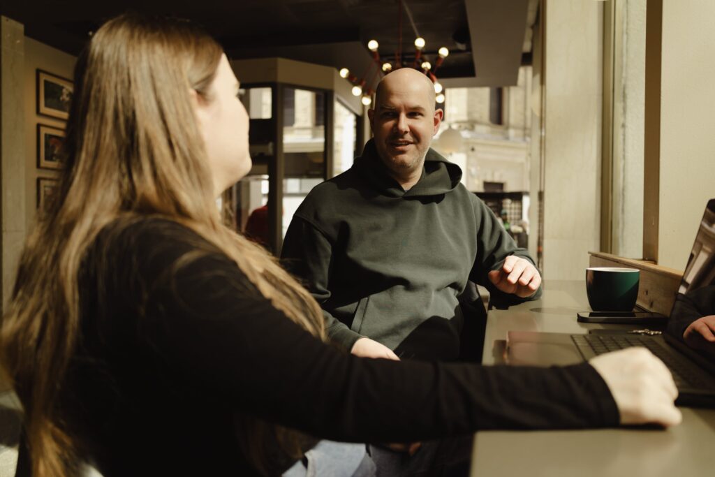 Michelle and Chad discussing a project in a cafe