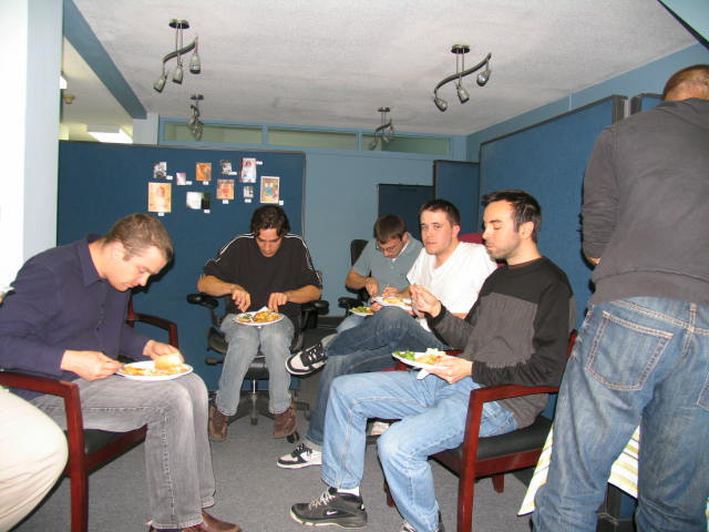 Employees enjoy a pot luck meal