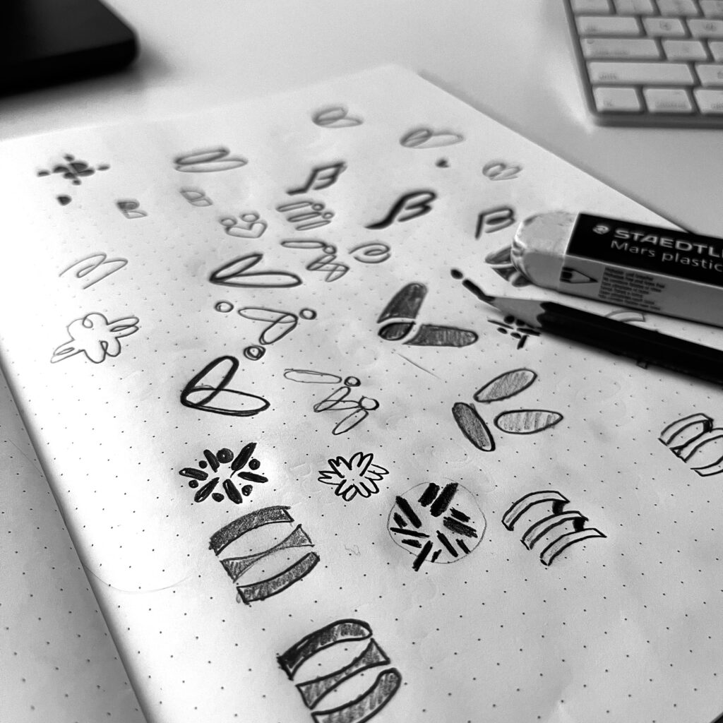 Various sketch attempts of the logo
